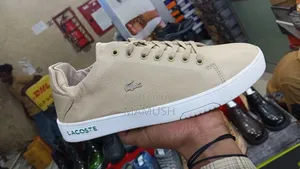 Photo - This Is Apair of Multicolor Lacoste Leather Snickers With a White Sole