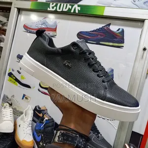 This Is Apair of Multicolor Lacoste Leather Snickers With a White Sole