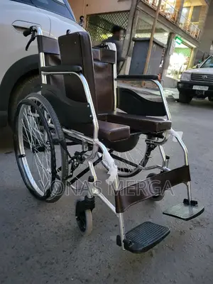 Commode Wheelchair= It Features A Chrome Or Silver-colored Metal Frame